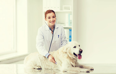 Image showing happy woman with dog and doctor at vet clinic