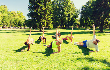Image showing group of happy friends exercising outdoors