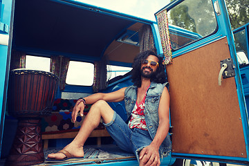 Image showing smiling young hippie man in minivan car