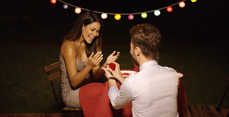 Image showing Young man down on his knees proposing