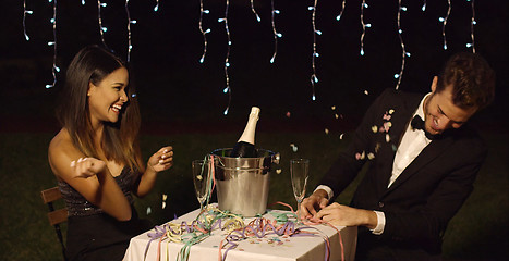 Image showing Couple celebrates with champagne in bucket