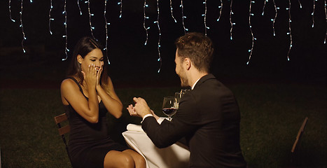 Image showing Shocked young woman receiving a marriage proposal