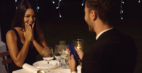 Image showing Young woman overcome when presented with a gift