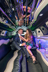 Image showing Young woman adjusting tie of boyfriend in limousine