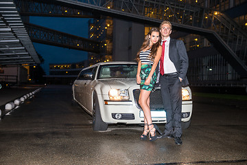 Image showing Full length portrait of elegant young couple standing in front o