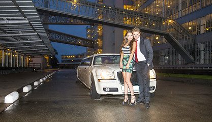 Image showing Cute couple in front of a limousine