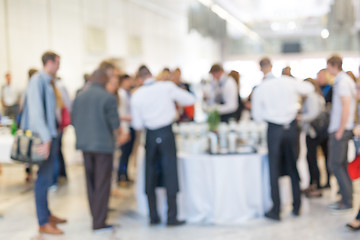 Image showing Abstract blurred people socializing during coffee break at business conference.