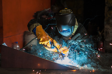 Image showing worker welding metal