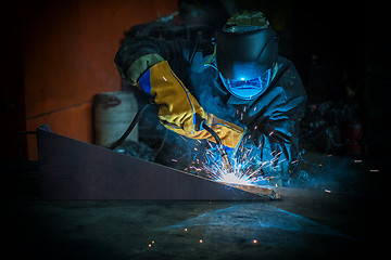 Image showing worker welding metal