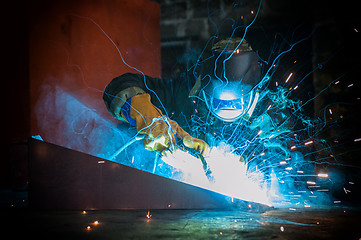 Image showing worker welding metal