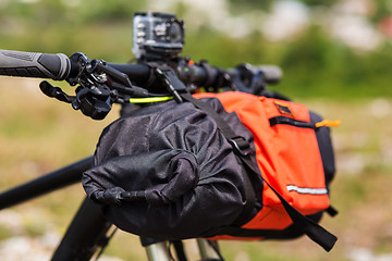 Image showing Bicycle with orange bags for travel