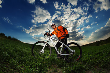 Image showing Man Cyclist with bike on sunset