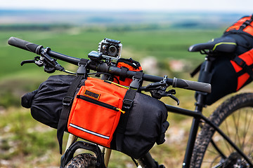 Image showing Bicycle with orange bags for travel