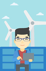 Image showing Man checking solar panels and wind turbines.