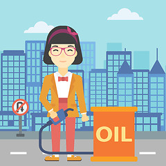 Image showing Woman with oil barrel and gas pump nozzle.