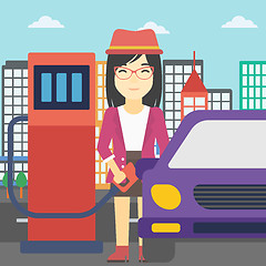 Image showing Worker filling up fuel into car.