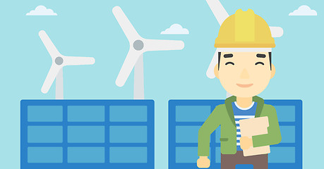 Image showing Male worker of solar power plant and wind farm.