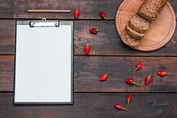 Image showing Office desk table with pencils, supplies and fresh bread