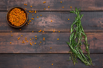 Image showing Bunch of rosemary on wooden table, rustic style