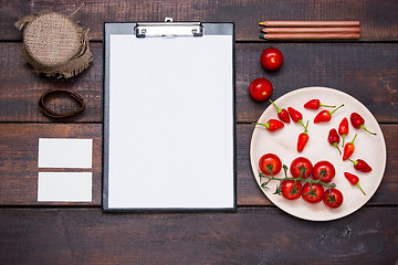 Image showing Office desk table with pencils, supplies and vegetables