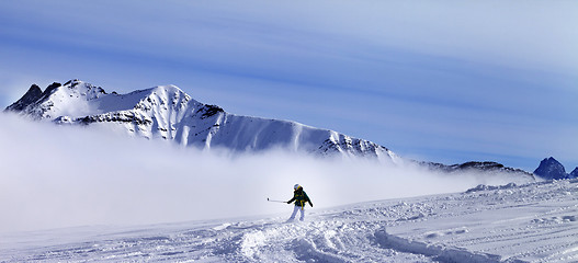 Image showing Panoramic view on snowboarder downhill on off-piste slope with n