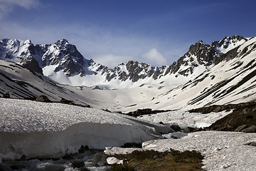 Image showing River with snow bridges in spring mountains at sun morning