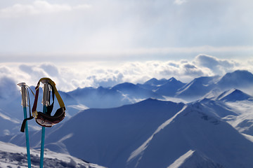 Image showing Ski mask on ski poles in evening sunlight mountains