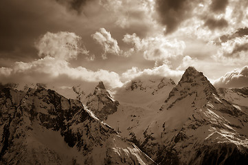 Image showing Winter snow mountains in clouds