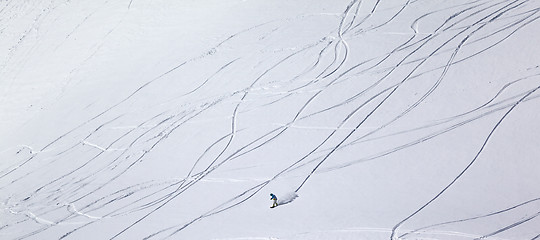 Image showing Panoramic view on snowboarder downhill on off piste slope with n