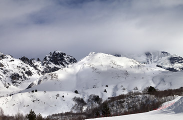 Image showing Ski resort and sunlight mountains in clouds