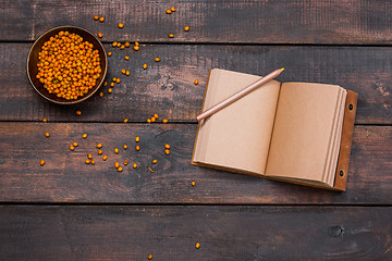 Image showing Office desk table with notebooks, fresh buckthorn berries on wooden table