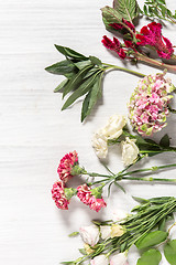 Image showing The flowers on white wooden background