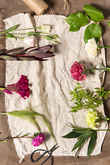 Image showing The flowers on white wooden background