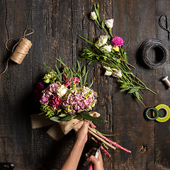 Image showing The florist desktop with working tools and ribbons
