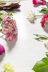 Image showing The flowers on white wooden background