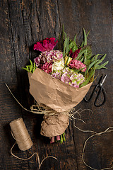 Image showing The flowers on wooden background