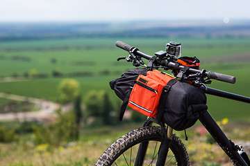 Image showing Bicycle with orange bags for travel