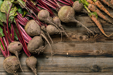 Image showing Young beets and carrots on wooden table