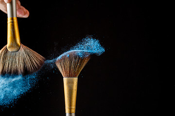 Image showing Beautiful splash after touch of two brushes.