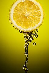 Image showing Fresh water drops on lemon at yellow background