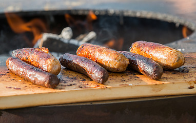 Image showing Grilling sausages on barbecue grill