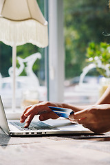 Image showing woman using laptop with credit card in hand