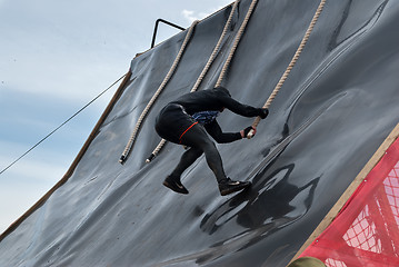 Image showing Sportsman storms big wall in extrim race. Tyumen