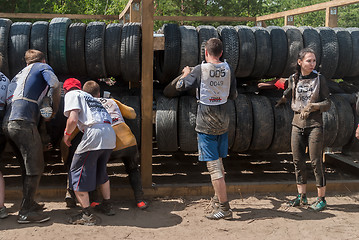 Image showing Sportsmen move between old tires. Tyumen