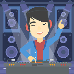 Image showing Smiling DJ mixing music on turntables.