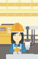 Image showing Woman working on industrial drilling machine.