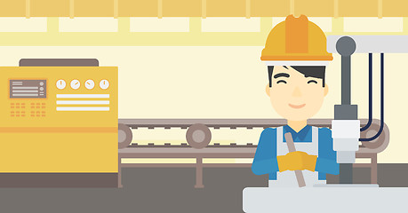 Image showing Man working on industrial drilling machine.