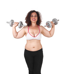 Image showing Woman lifting dumbbells.