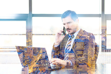 Image showing Businessman in office working on laptop computer.