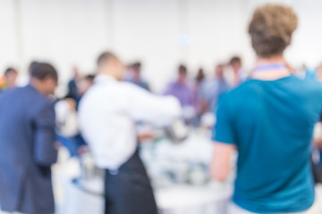 Image showing Abstract blurred people socializing during coffee break at business conference.